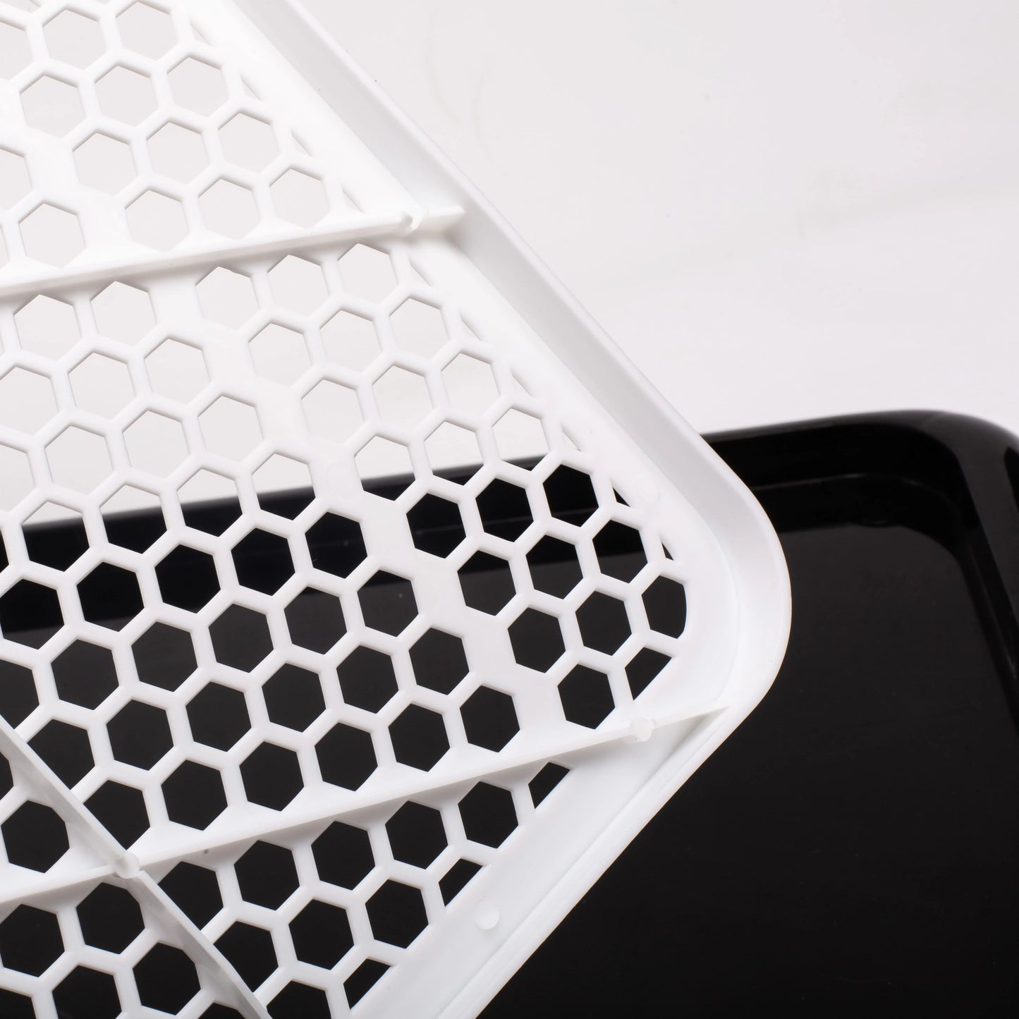 Honeycomb pattern close-up of Pet Awesome dog potty tray grid surface