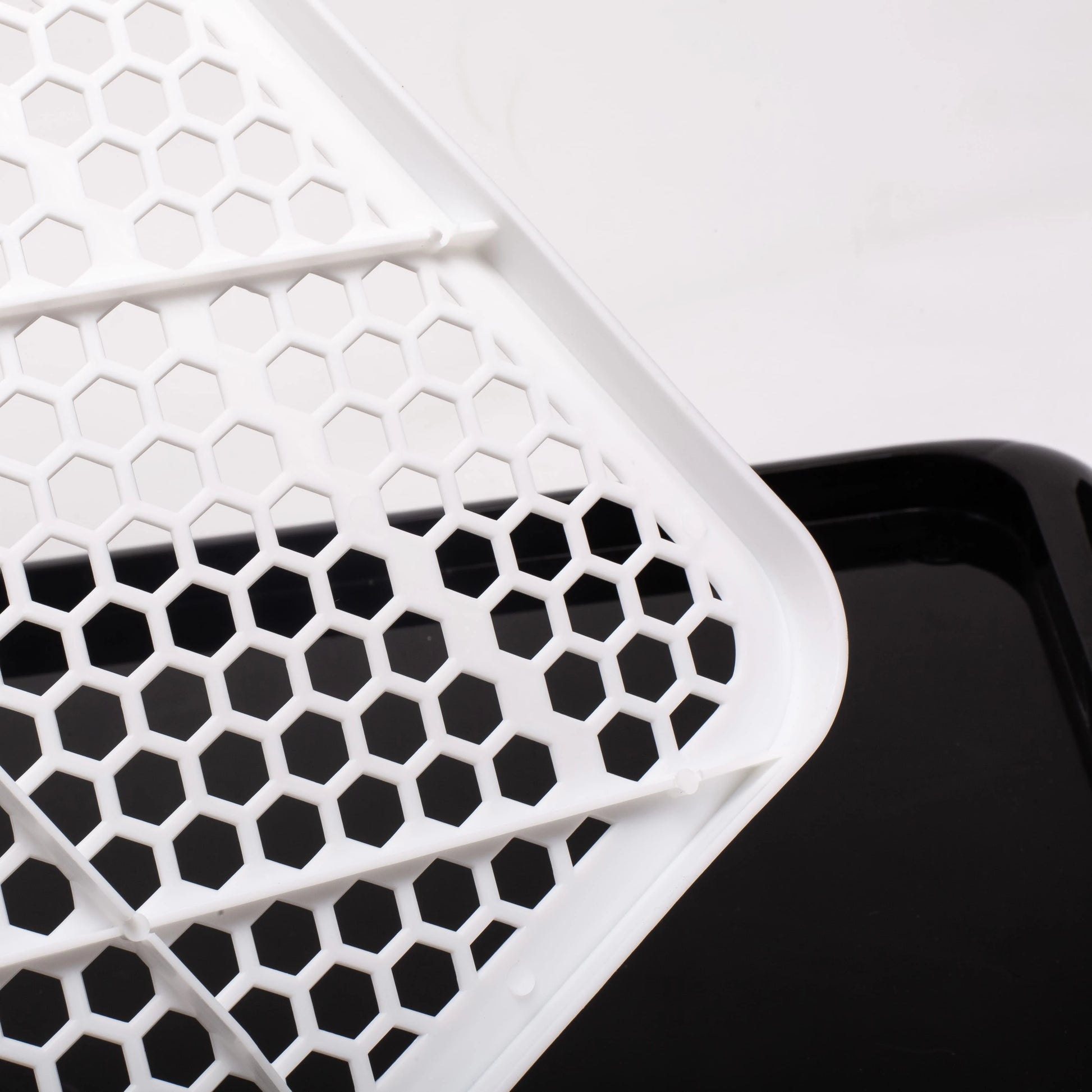 Honeycomb pattern close-up of Pet Awesome dog potty tray grid surface