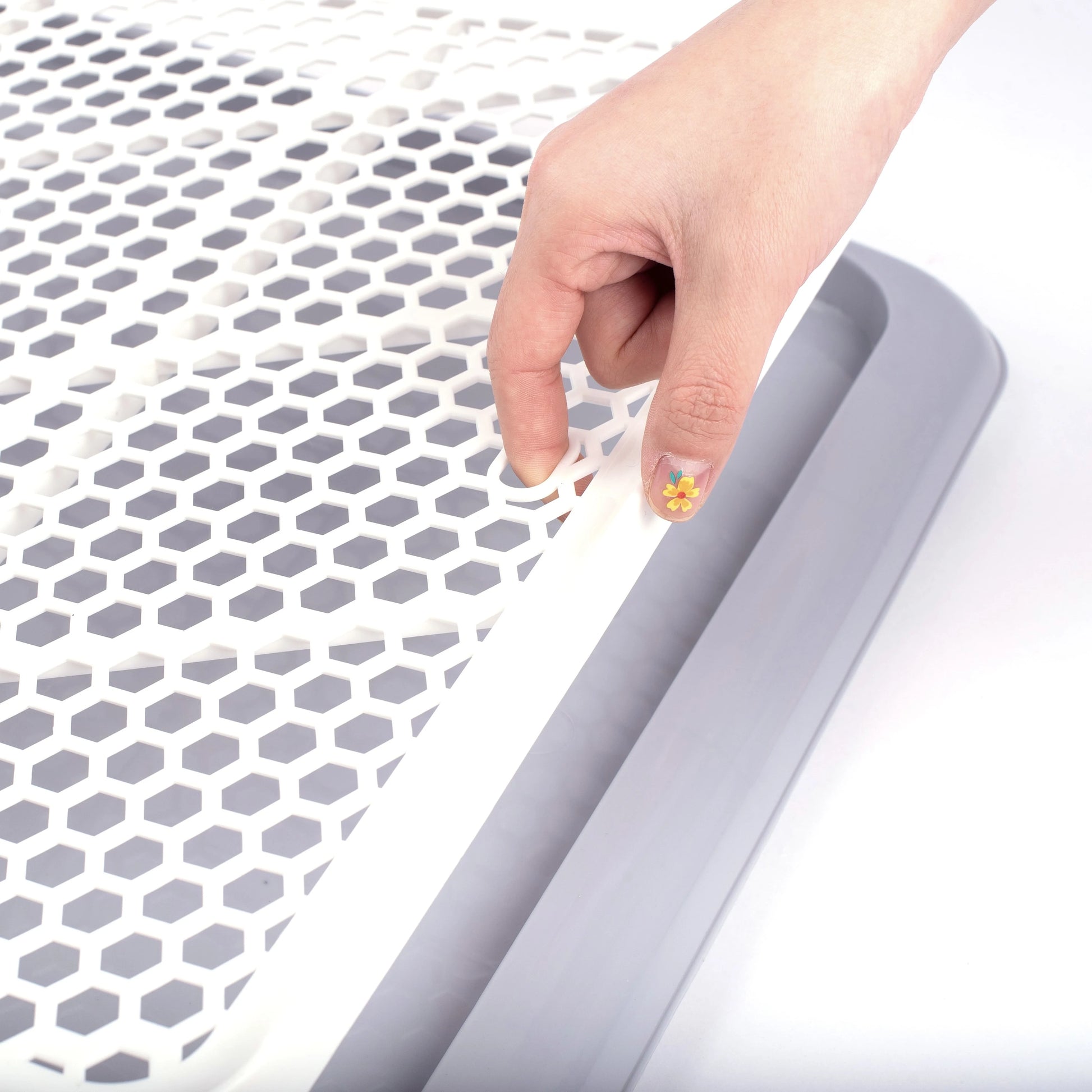 Close-up of Pet Awesome dog potty tray removable grid top for easy cleaning