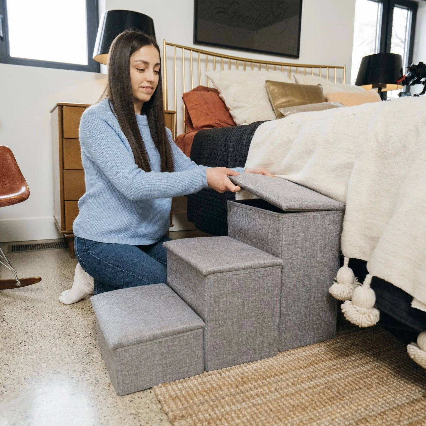 Woman lifting top of Pet Awesome grey dog stairs to reveal hidden storage space