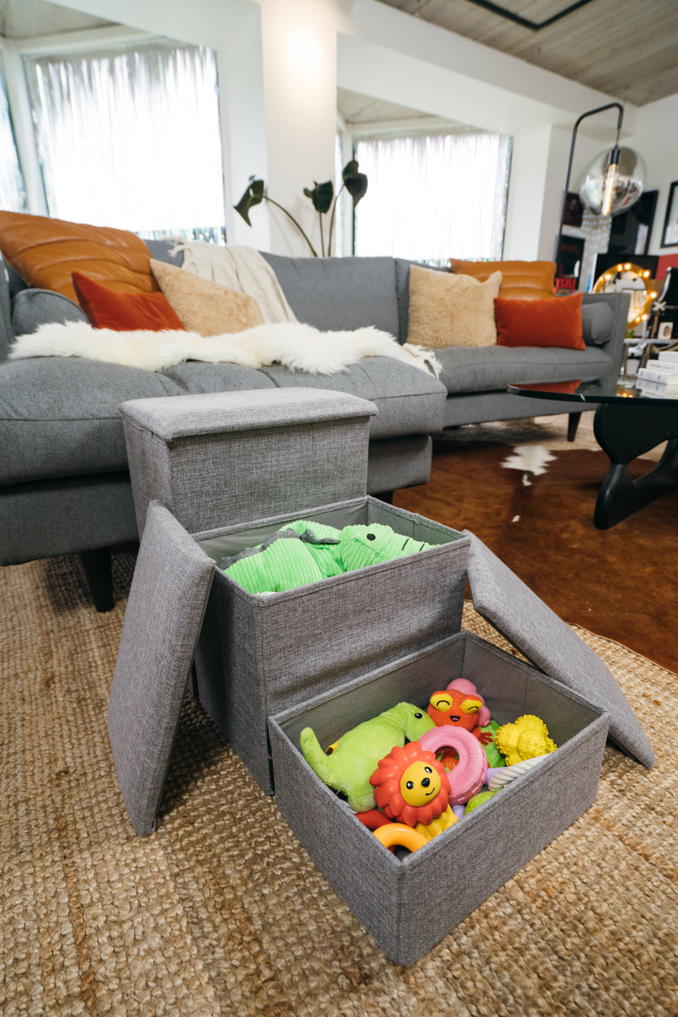 Grey dog stairs with open storage compartments holding pet toys